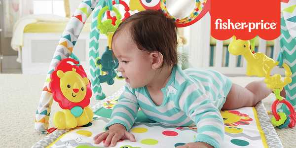A baby playing with Fisher-Price Carnival 3-in-1 musical activity baby gym.
